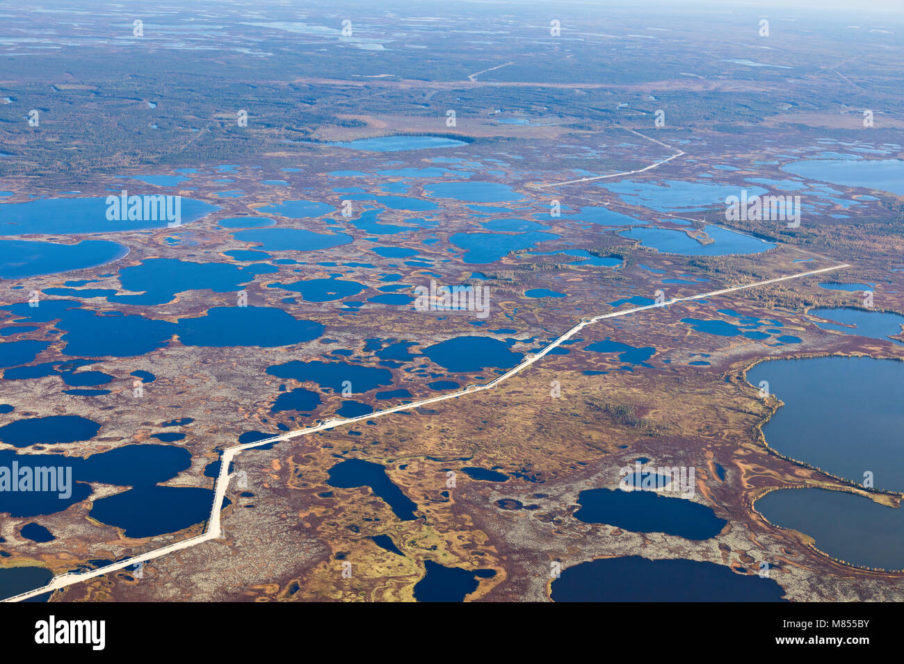 Top view of gas pipeline in endless swamps in tundra Stock Photo