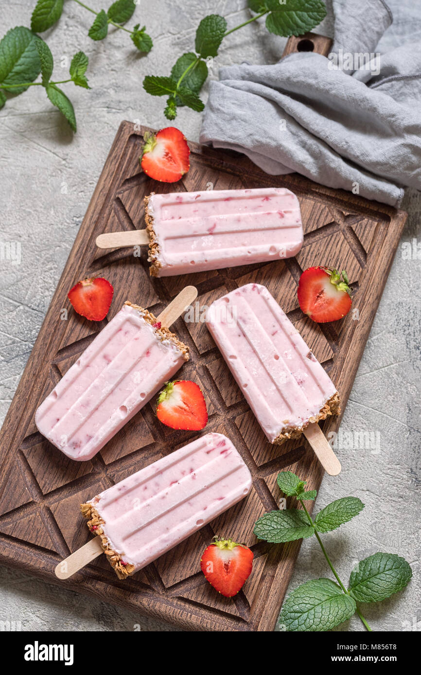 Yogurt, berry and granola breakfast popsicles on a tray Stock Photo