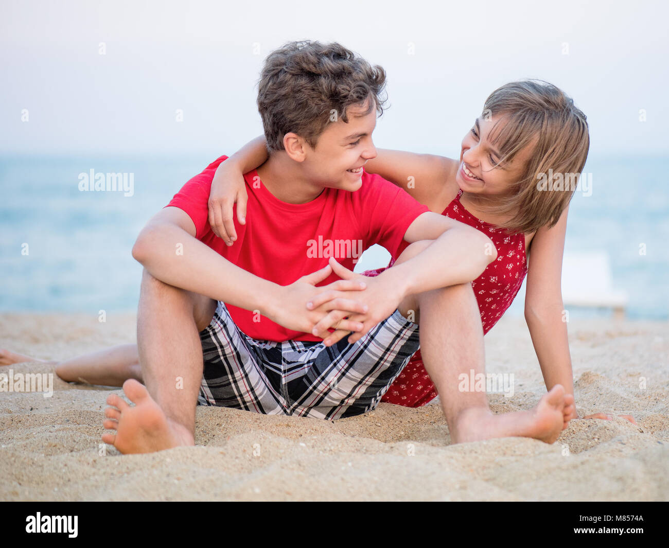 Brother and sister playing on beach Stock Photo