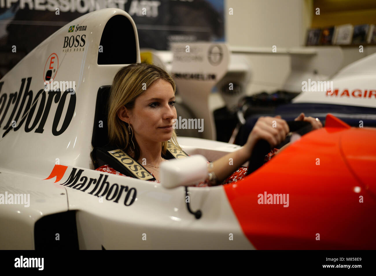 A Bonhams employee sits in the 1993 McLaren-Ford MP4/8A Formula 1 racer,  driven to victory by legendary racing driver Ayrton Senna in his final  Monaco Grand Prix, on show at Bonhams in