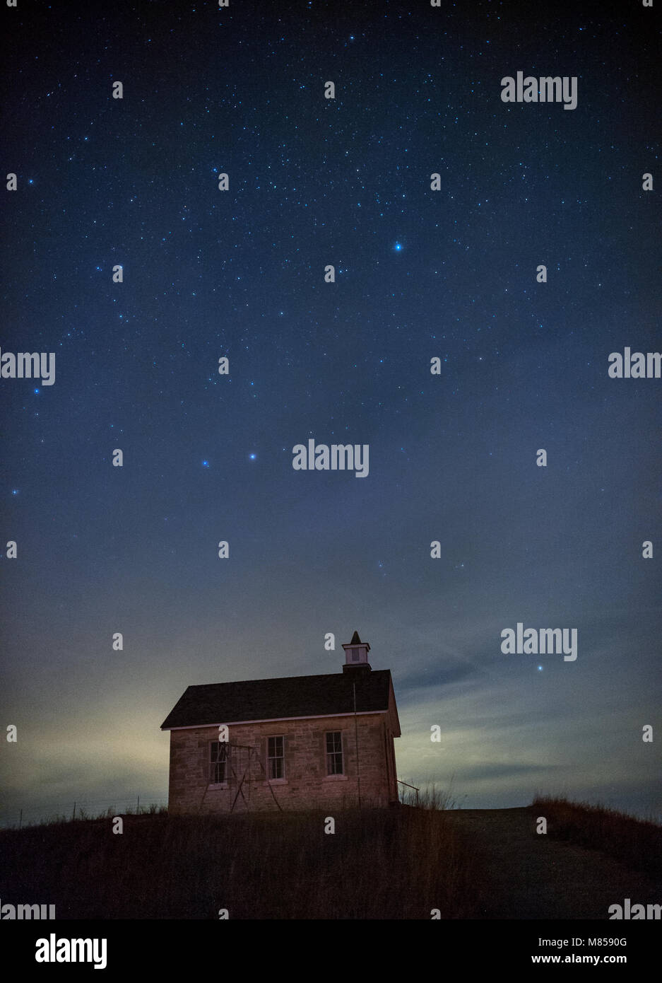 Stars at night over the Lower Fox Creek Schoolhouse in the Tallgrass Prairie National Preserve, Flint Hills, Kansas, USA Stock Photo