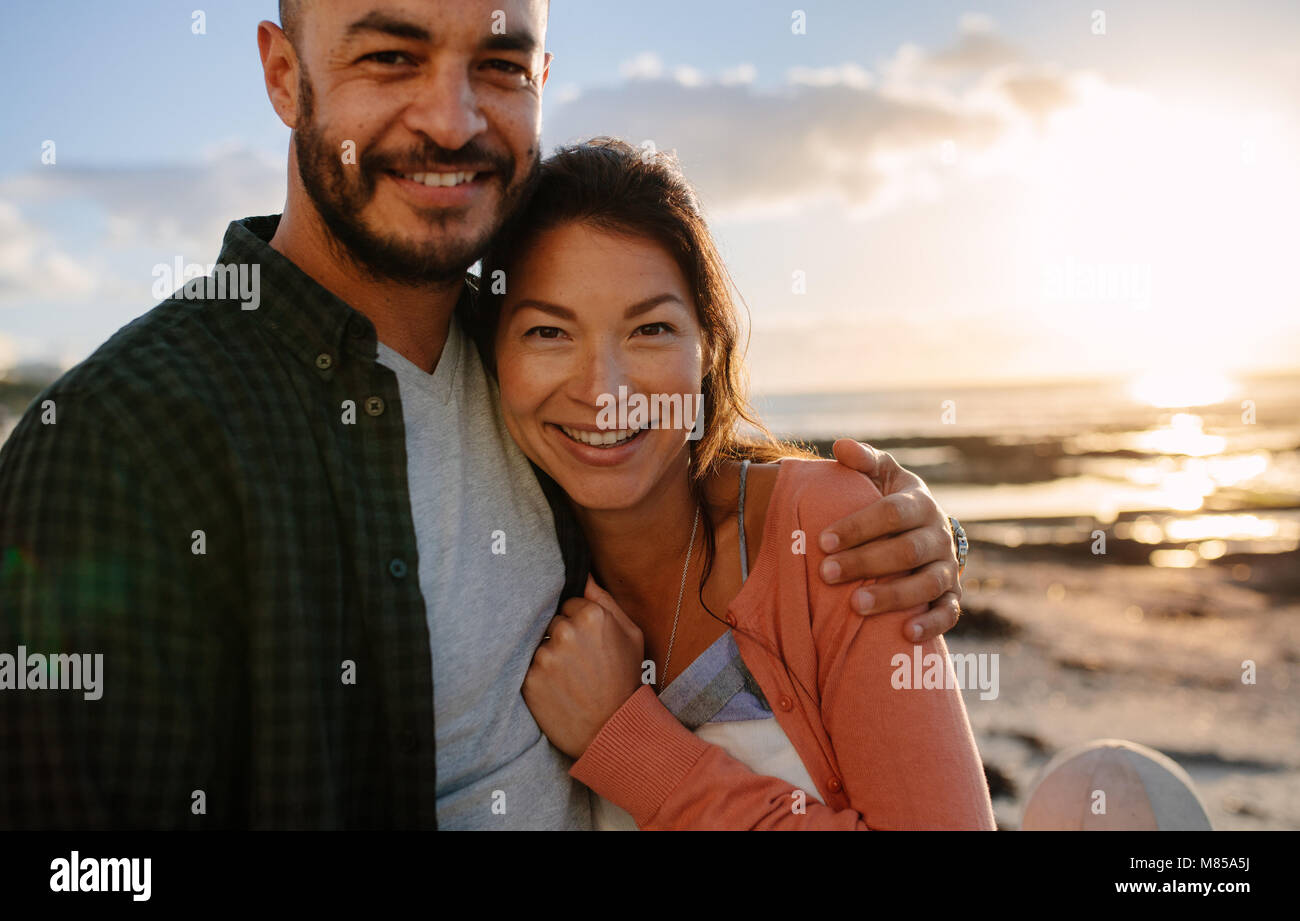 Man holding arm around woman hi-res stock photography and images - Alamy