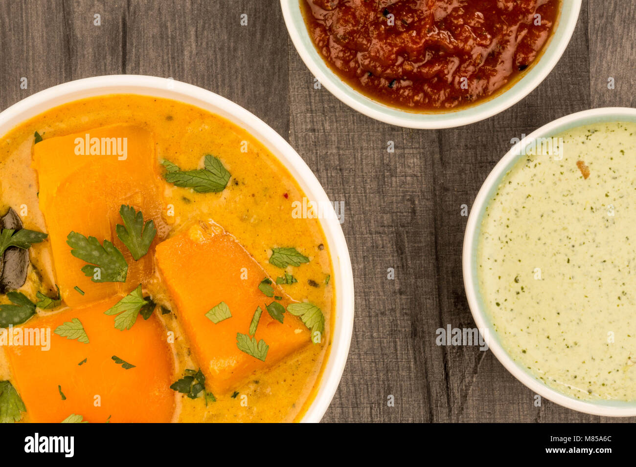 Indian Style Butternut Squash Curry Against A Dark Wooden Table Top