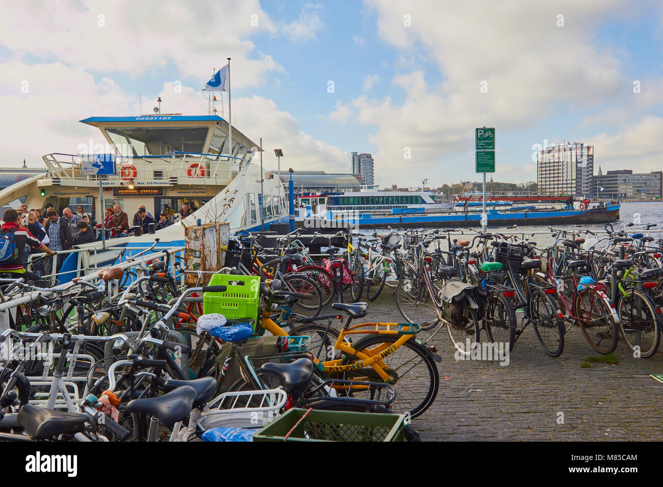 Foot passengers disembarking from ferry and bicycle park, Overhoeks, a new mixed use neighbourhood, Amsterdam, Netherlands Stock Photo