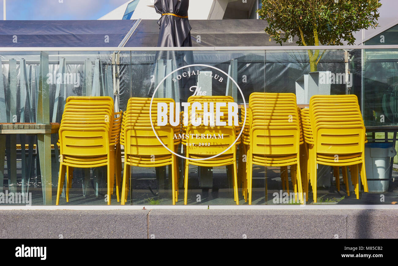Stacked yellow chairs, The Butcher Social Club, Overhoeks, Amsterdam-Noord, Amsterdam, Netherlands. Stock Photo
