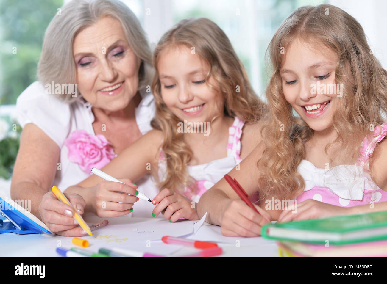 Senior woman with girls drawing Stock Photo