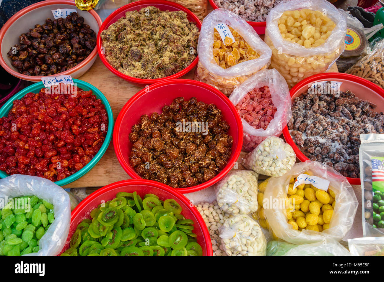 Dried fruit and nuts in bowls for sale at an outdoor market in Hoi An, Vietnam Stock Photo