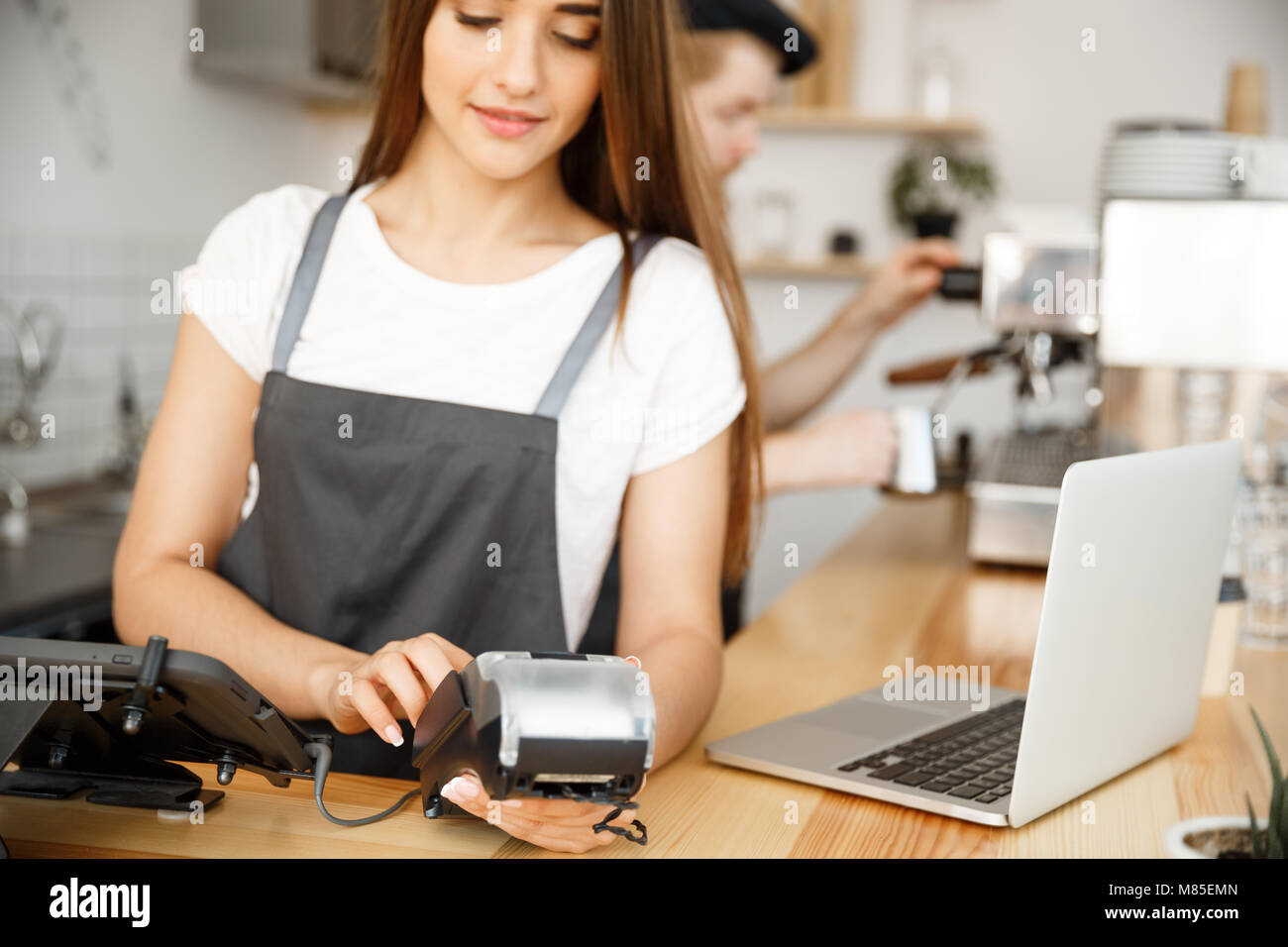 Coffee Business Concept Beautiful female barista giving payment