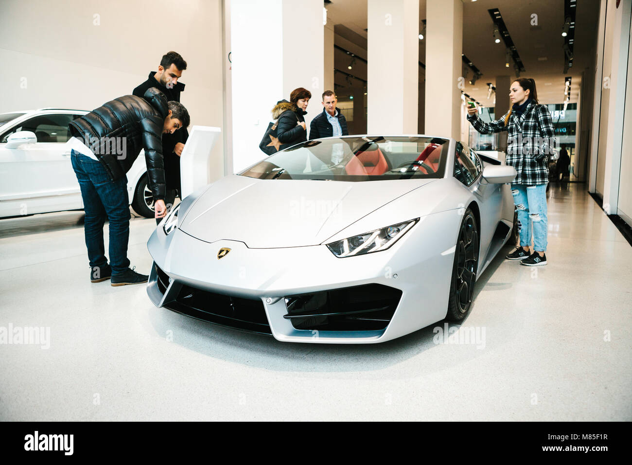 Volkswagen Group Forum - auto show in Berlin. Close-up. Buyers and visitors are watching the new Lamborghini sports car. Stock Photo