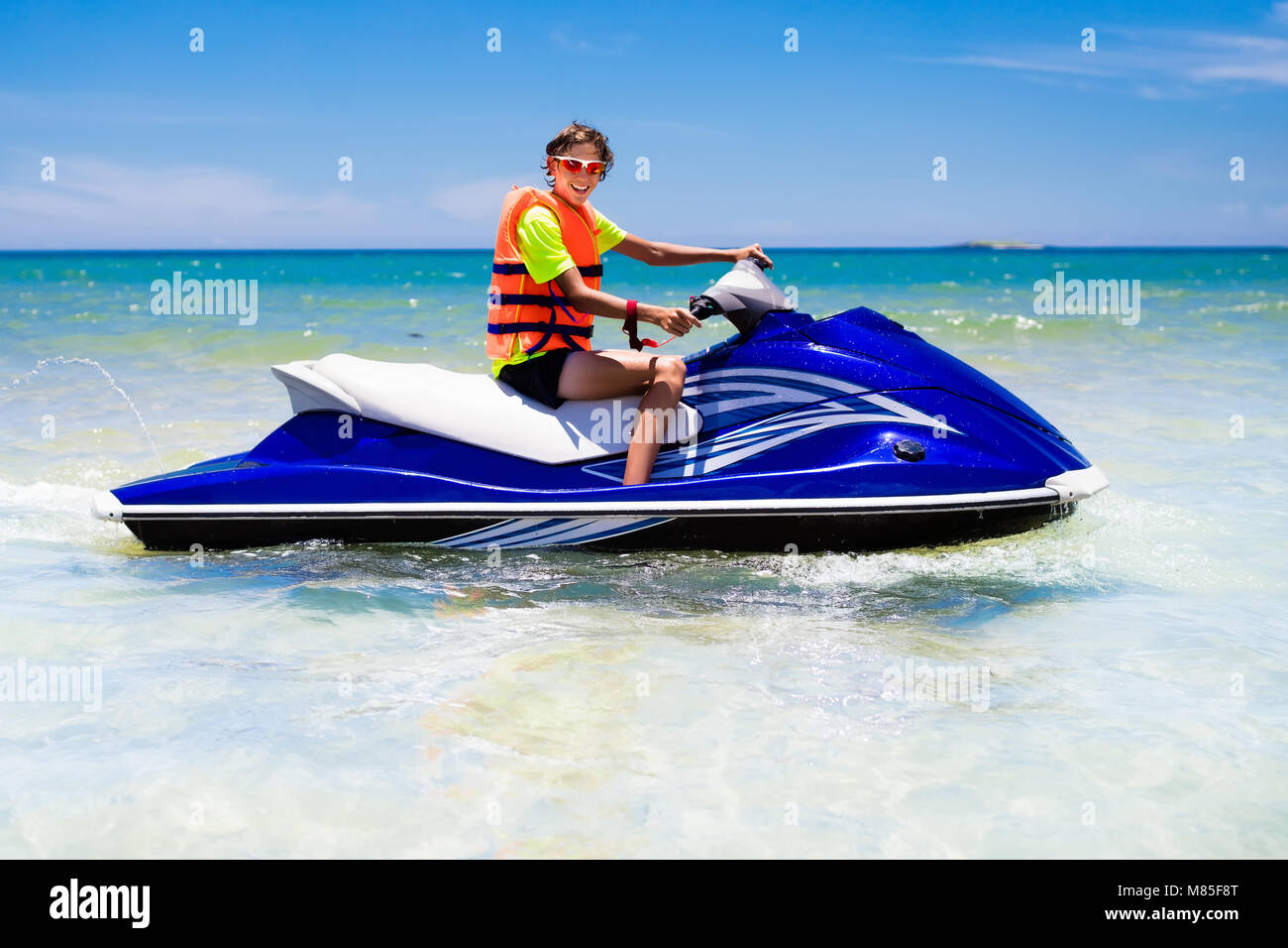 Teenager on jet ski. Teen age boy skiing on water scooter. Young man on  personal watercraft in tropical sea. Active summer vacation for school  child Stock Photo - Alamy