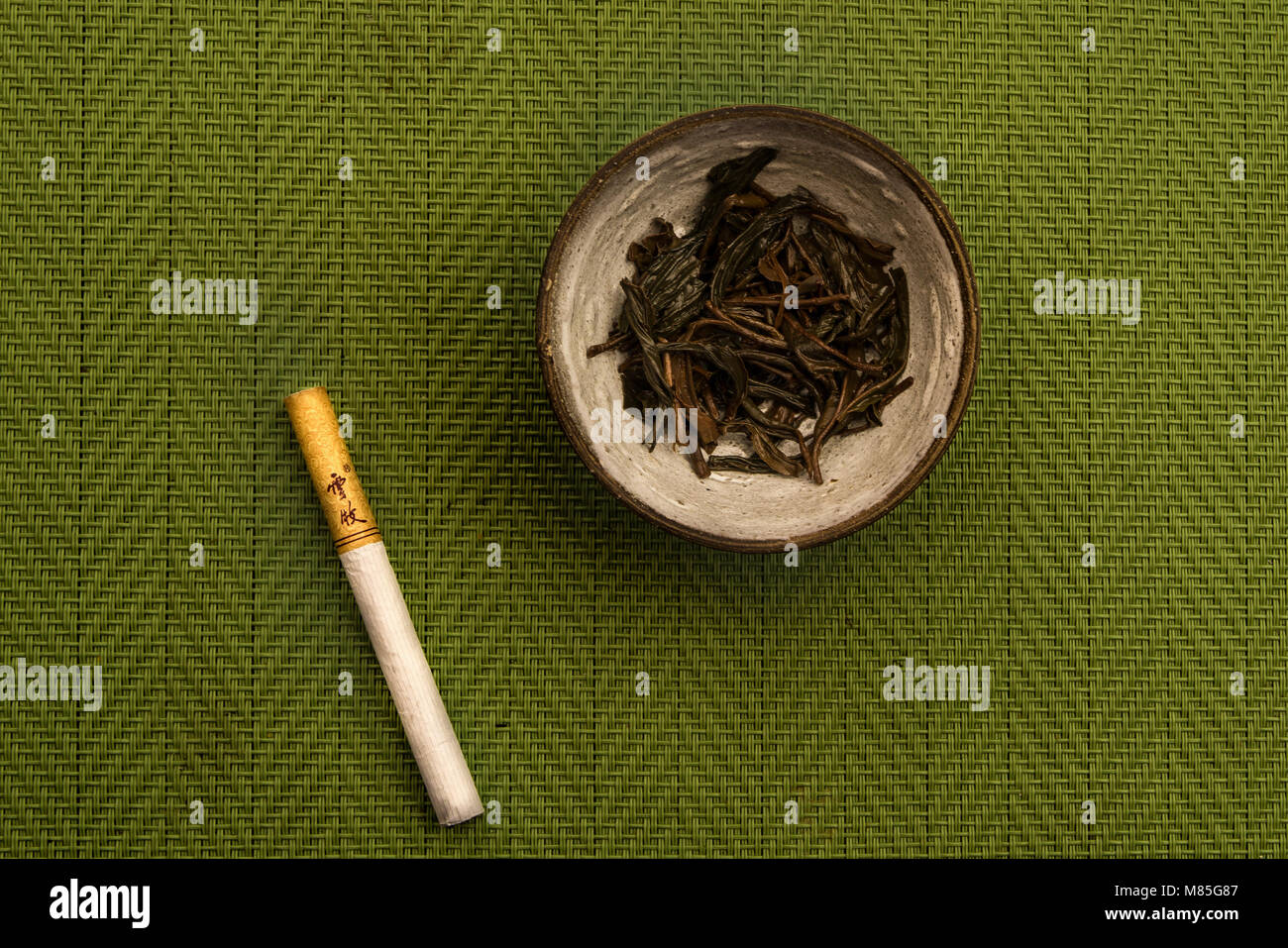 brewed Tea and the cigarette made of red tea Stock Photo