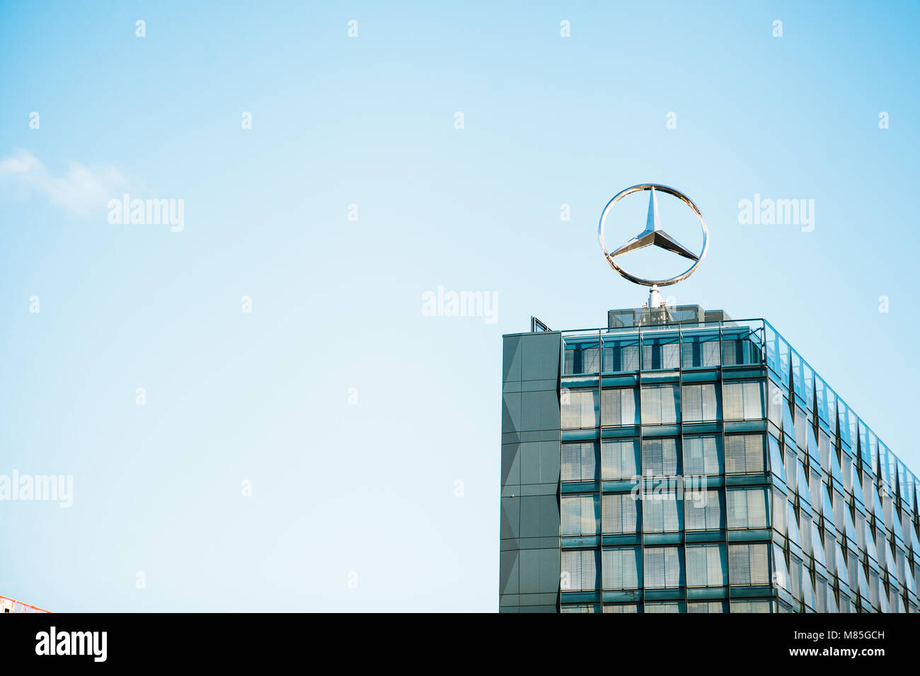 The symbol of Mercedes Benz on the roof of the central office building of the international engineering corporation Mercedes Benz. Stock Photo