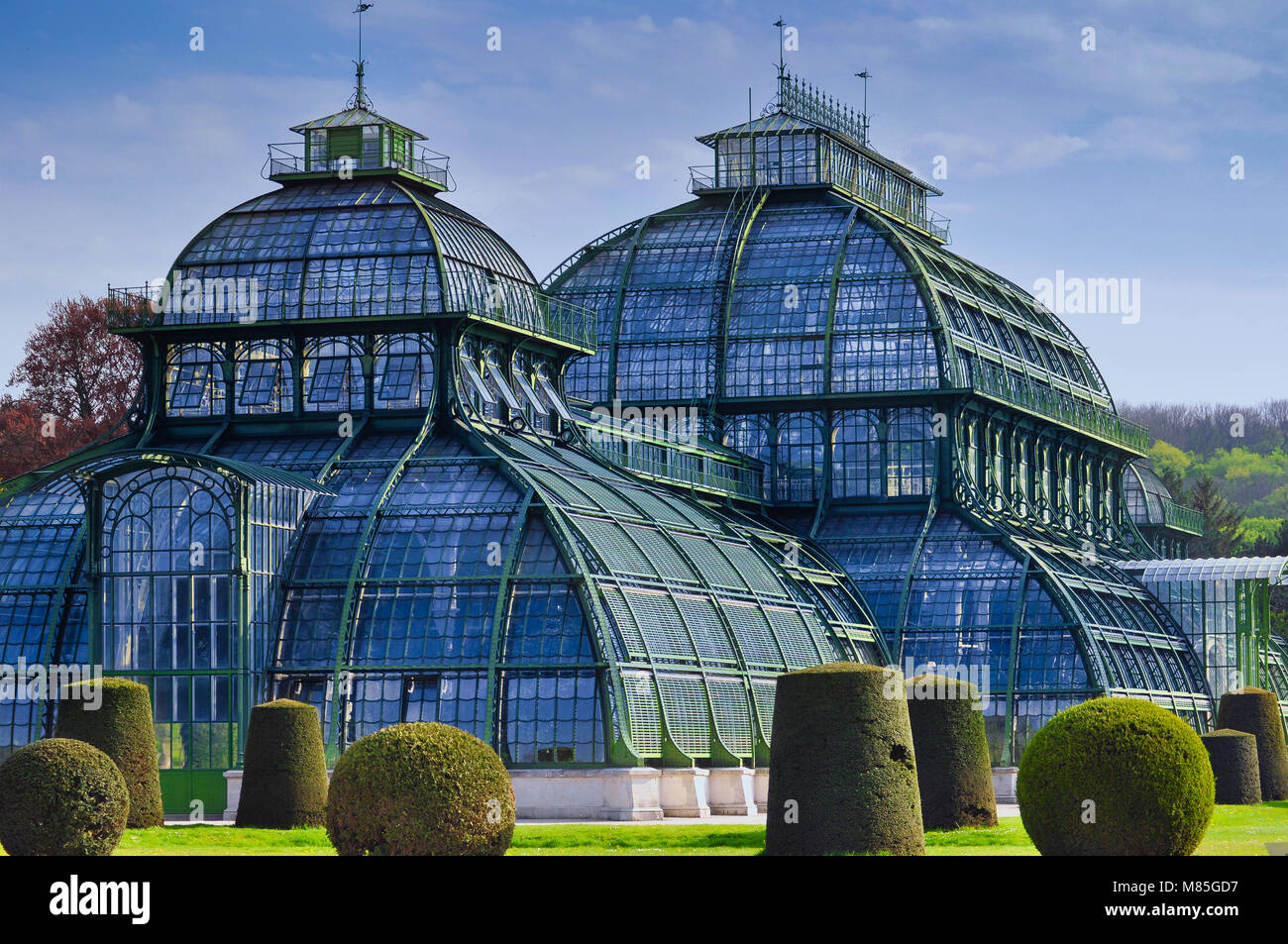 Green house Palmenhaus Schonbrunn in Schonbrunn palace park. Opened in 1882, it is the most prominent of the four greenhouses in Schonbrunn Stock Photo