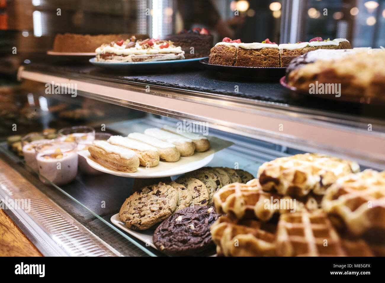 Large selection of cakes and pastries on the counter in a cafe. Sale of delicious sweets Stock Photo