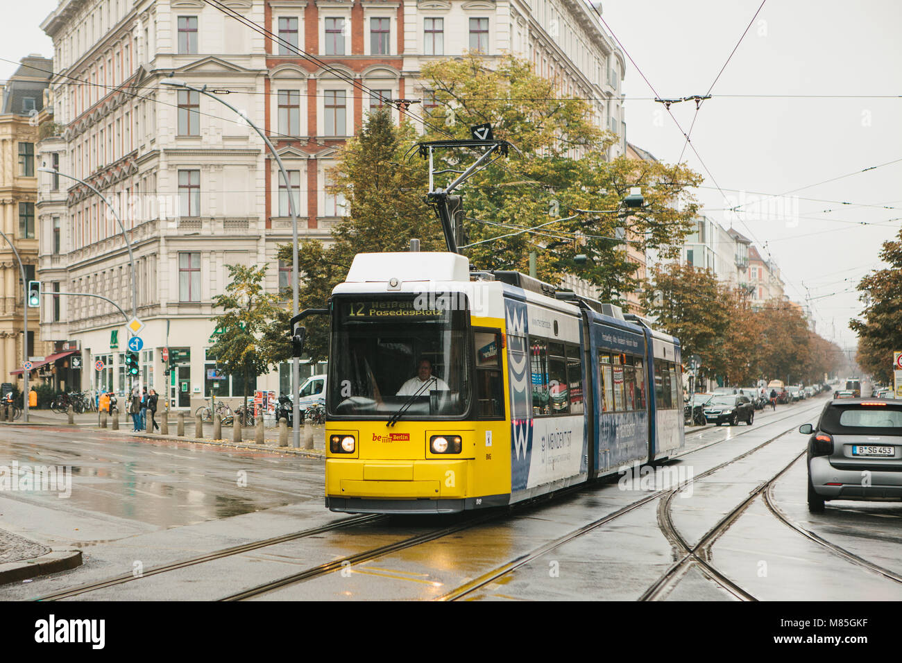 Berlin, October 2, 2017: City public transport in Germany. Beautiful black and yellow train stopped at stop on the background of an old building Stock Photo