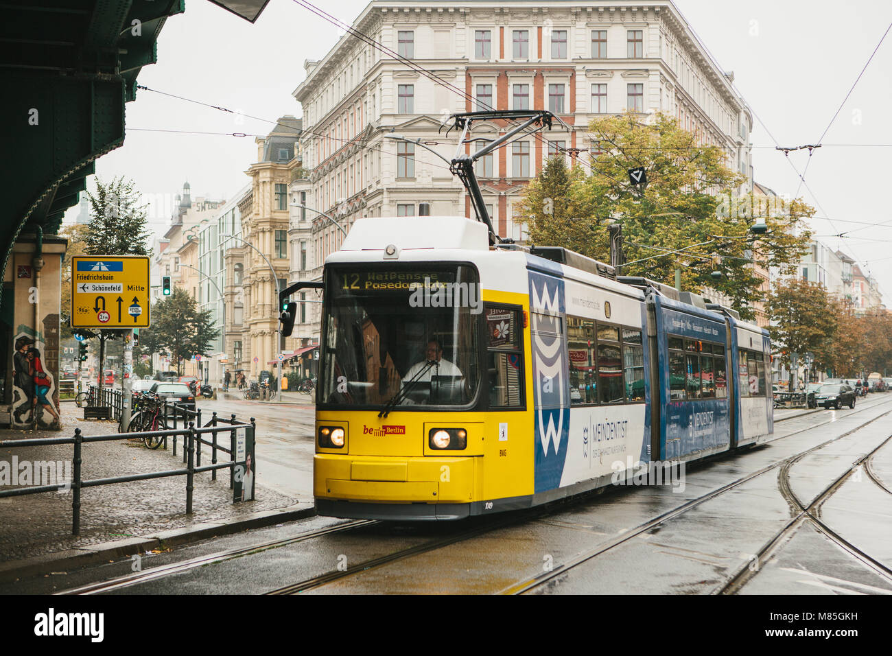 Berlin, October 2, 2017: City public transport in Germany. Beautiful black and yellow train stopped at stop on the background of an old building. Stock Photo