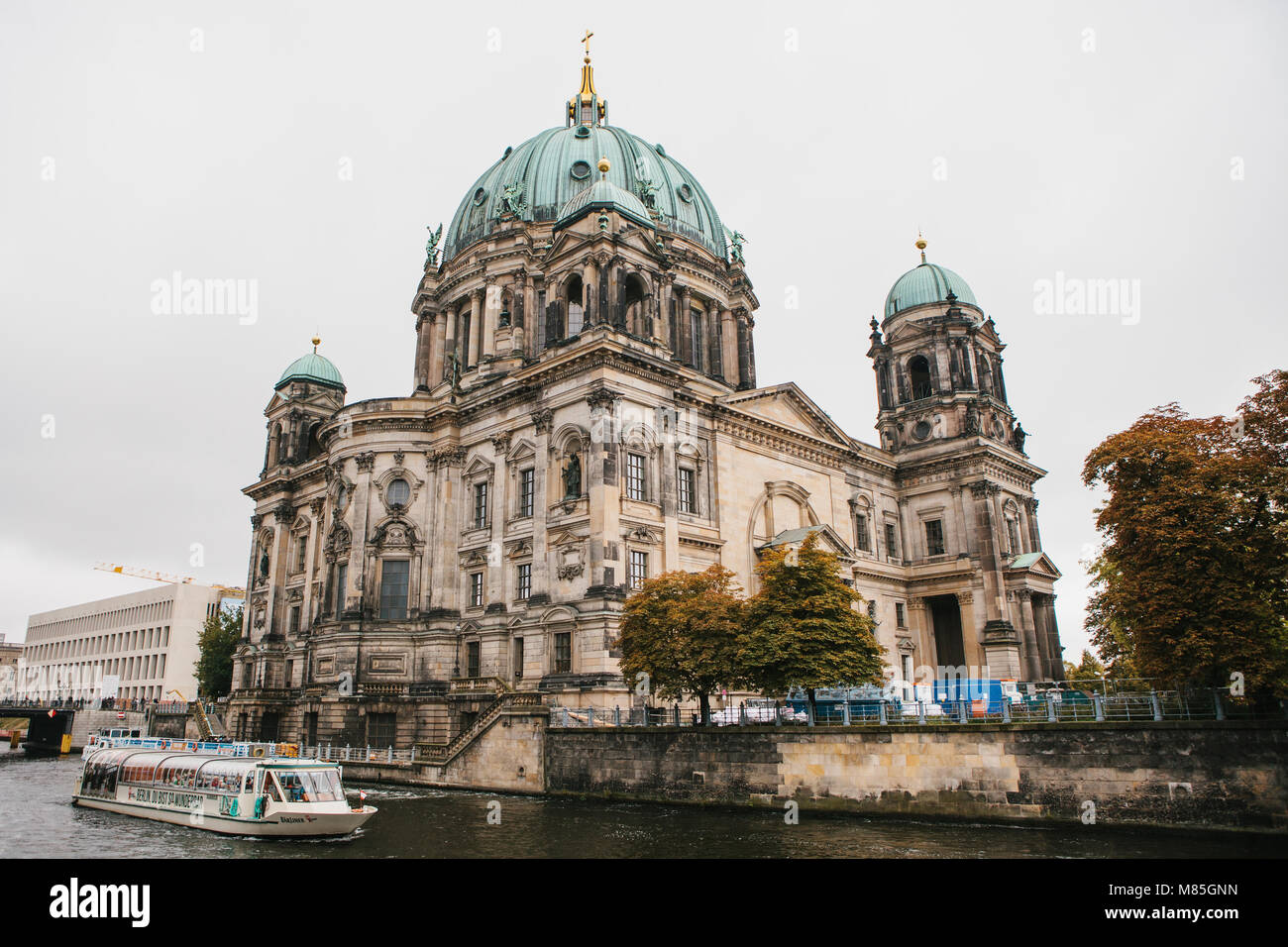 Berlin, October 1, 2017: Berlin Cathedral Berliner dom- beautiful old building with green dome next to the river Spree and tourist boats Stock Photo