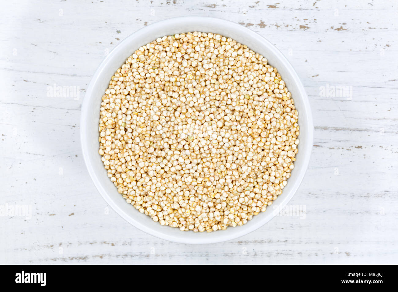 Quinoa grain superfoods superfood grains from above bowl wooden board wood Stock Photo