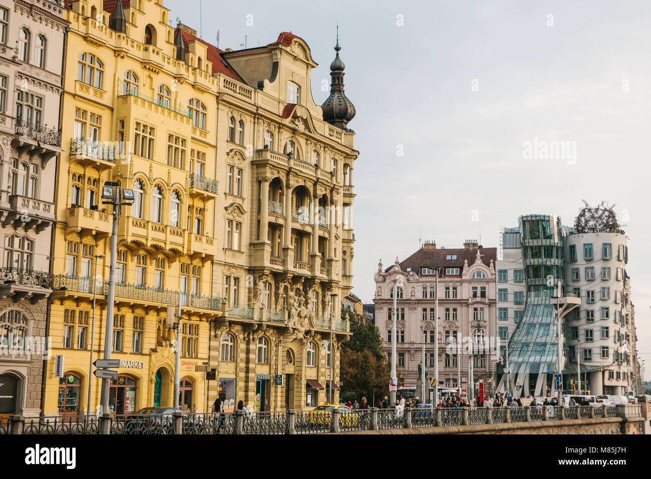 An old building next to a modern building called the Dancing House. Beautiful view of the architecture of Prague in the Czech Republic Stock Photo