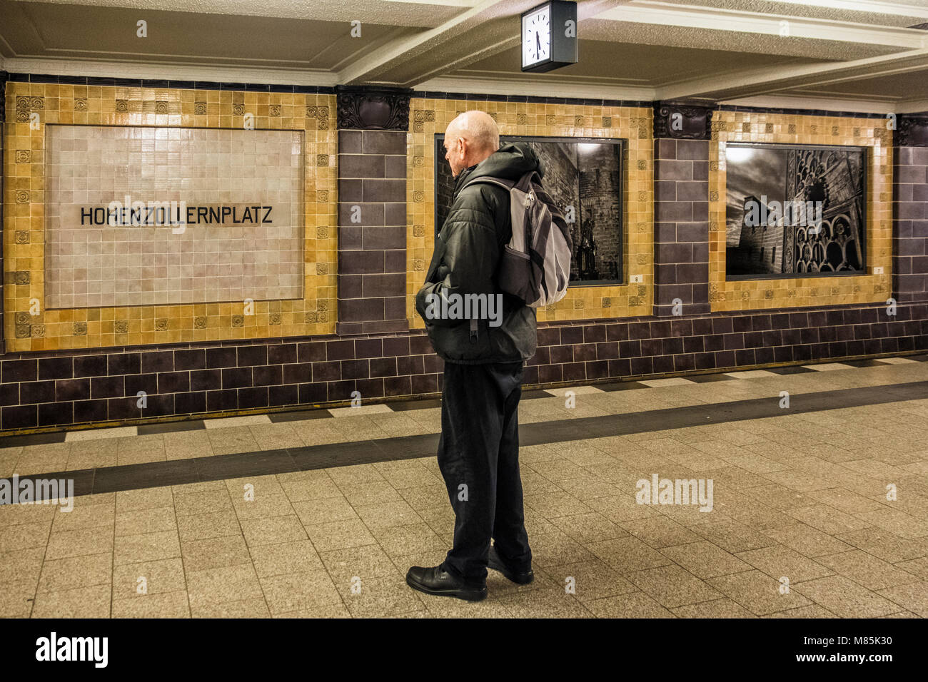 Berlin Wilmersdorf district,Hohenhollernplatz U3 U-Bahn underground railway station interior. Senior elderly man waiting on platform Stock Photo