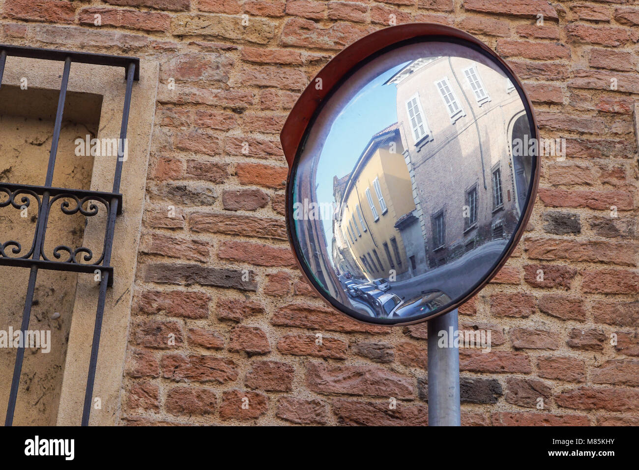 Traffic mirror, Mirror of spherical type reflecting the cross for improving visibility Stock Photo