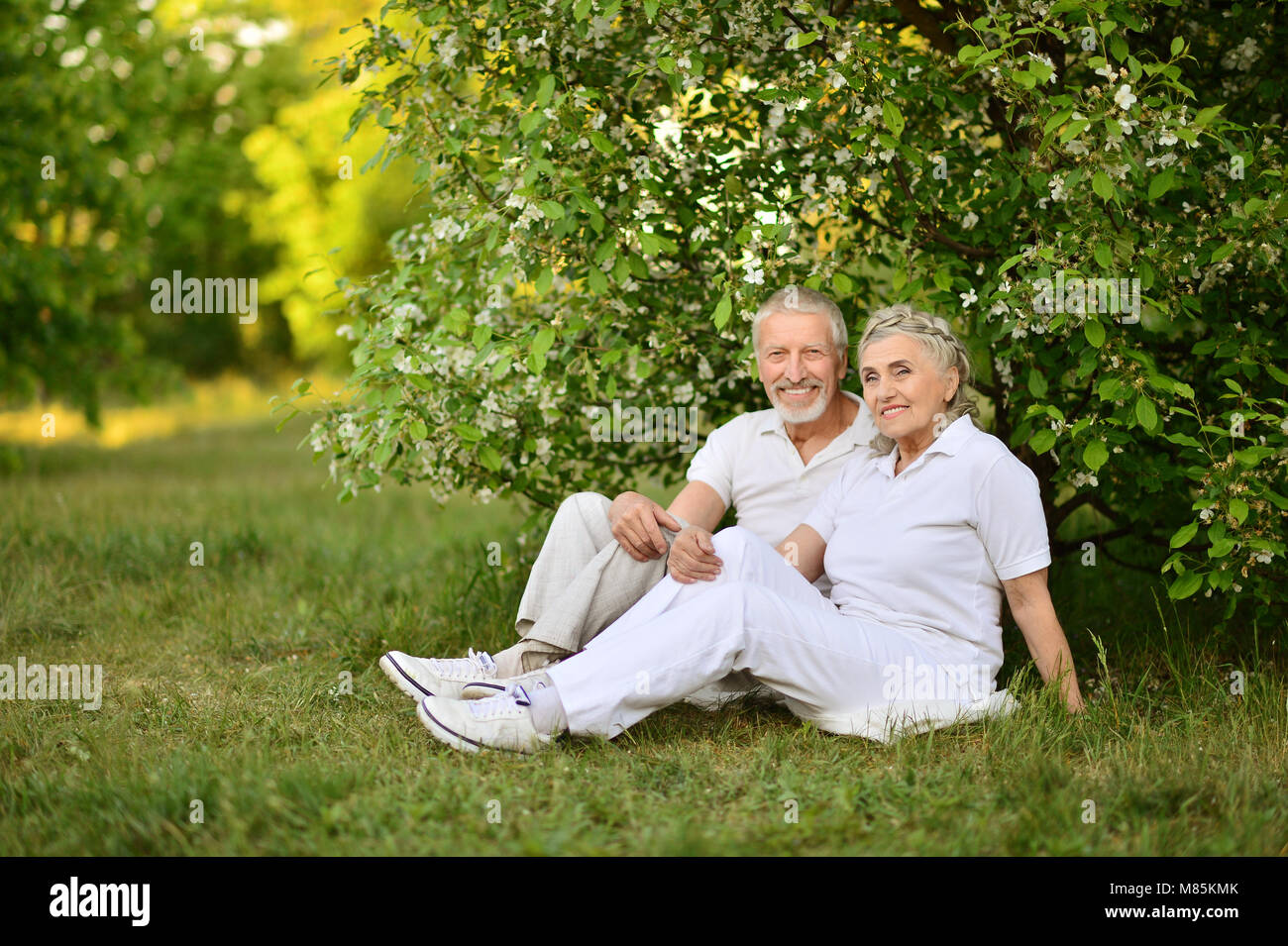 Happy senior couple sitting outdoors Stock Photo - Alamy