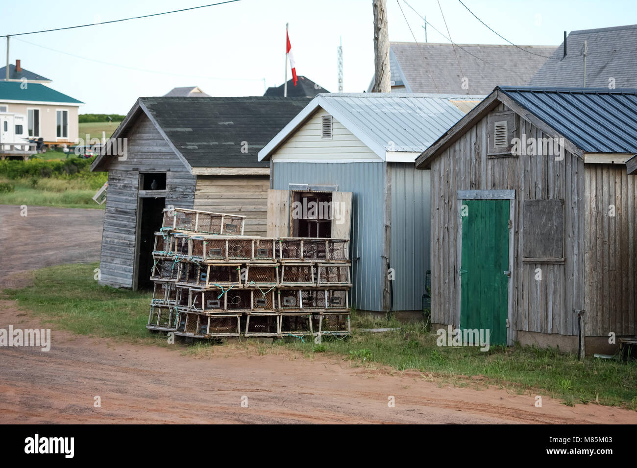 Fishing sheds and lobster traps sit by the road side near North Lake, P.E.I. on August 25, 2017. Stock Photo