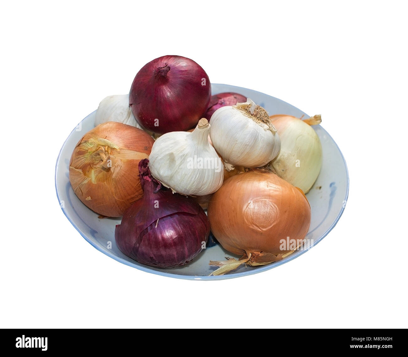 Fresh onions on dark plate isolated on white Stock Photo