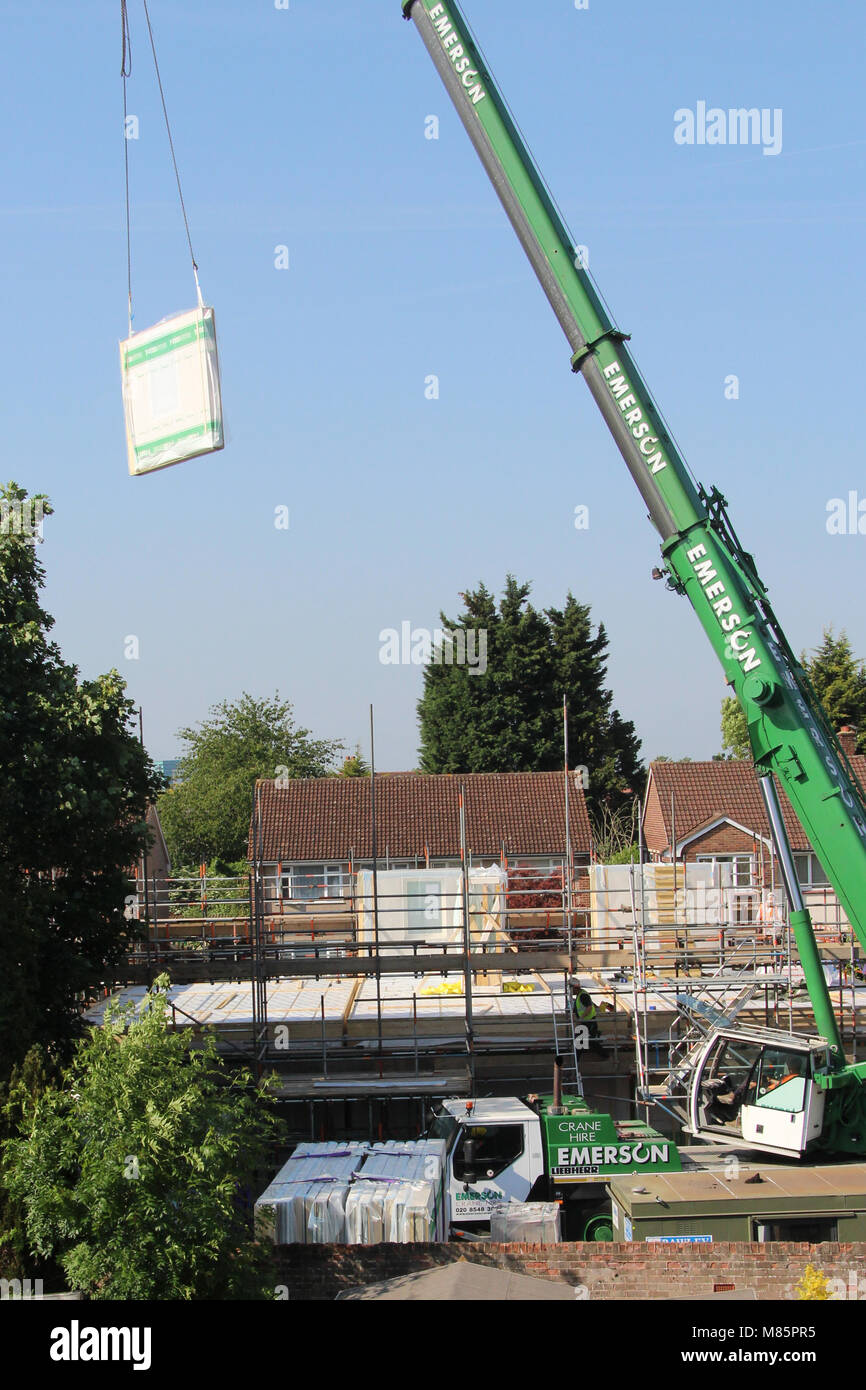 A Crane Hoisting a Structural Insulated Panel (SIP) Stock Photo