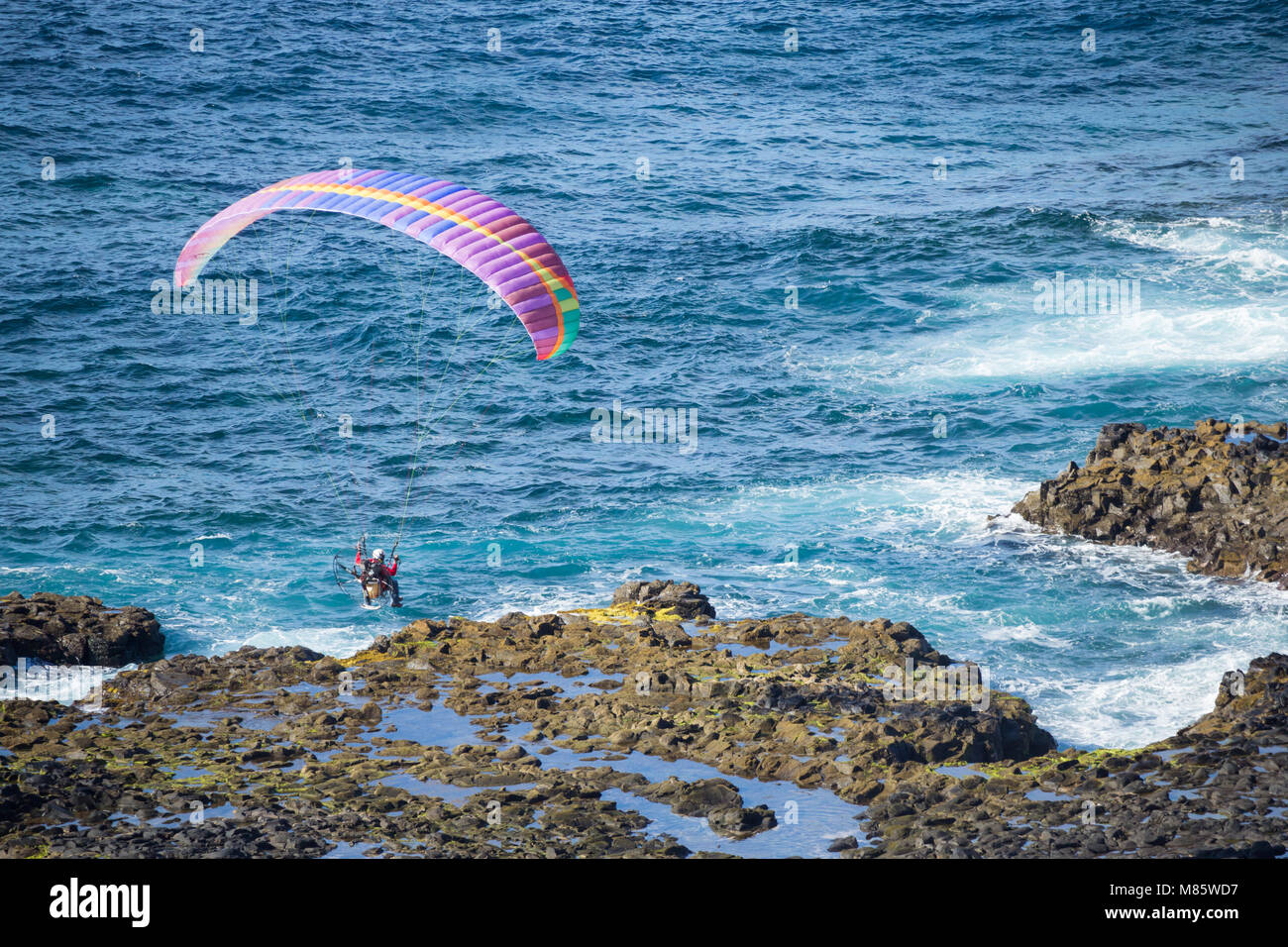 Las Palmas, Gran Canaria, Canary Islands, Spain. 14th March, 2018.  Motorized paraglider flying over the Atlantic ocean from cliff top take off near Las Palmas, the capital of Gran Canaria, in glorious sunshine. Credit: ALAN DAWSON/Alamy Live News Stock Photo