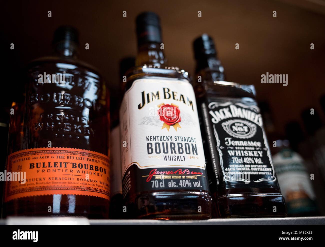 14 March 2018, Germany, Hamburg: A variety of whiskey brands from the United States are stacked on a shelf in a supermarket. The President of the European Commission, Jean-Claude Juncker, has announced to take action in light of the recently announced implementation of US tariffs on imported products to the US. The EU commission is currently examining possible import surcharges on US products such as whiskey, motorcycles and peanut butter. Photo: Christian Charisius/dpa Stock Photo