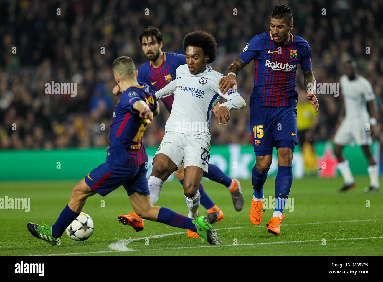 Barcelona, Spain. 14th March 2018; Willian, Chelsea FC player in action with Paulinho, #15 player of FC Barcelona and Andre Gomes, #21 player of FC Barcelona during the 2017/2018 UEFA Champions League Round of 16 game between FC Barcelona and Chelsea at Camp Nou stadium on March 14, 2018 in Barcelona, Spain. Credit: UKKO Images/Alamy Live News Stock Photo