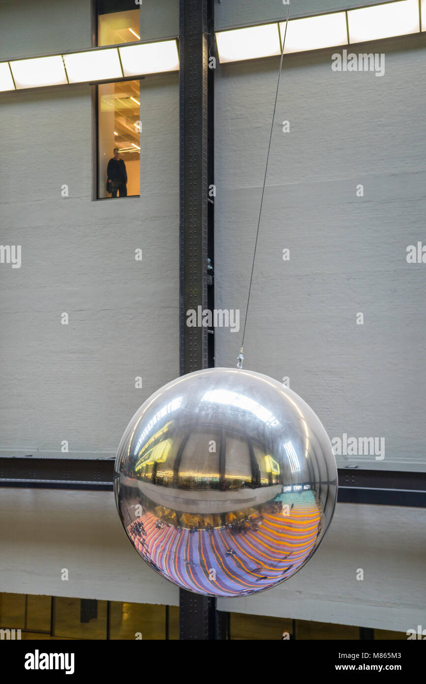 London, UK. 15th March, 2018. A huge reflective metal ball swings in the Turbine Hall of the Tate Modern, part of Danish art collective Superflex interactive installation called One Two Three Swing!. Credit: Roger Garfield/Alamy Live News Stock Photo