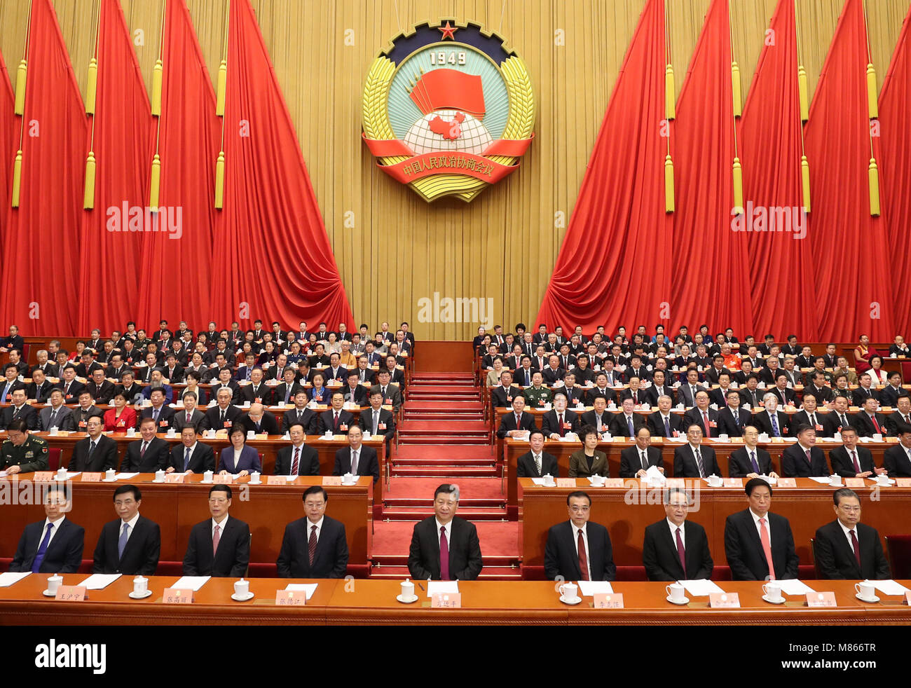 Beijing, China. 15th Mar, 2018. Xi Jinping (C, front), Li Keqiang (4th R, front), Zhang Dejiang (4th L, front), Yu Zhengsheng (3rd R, front), Zhang Gaoli (3rd L, front), Li Zhanshu (2nd R, front), Wang Huning (2nd L, front), Zhao Leji (1st R, front) and Han Zheng (1st L, front) attend the closing meeting of the First Session of the 13th National Committee of the Chinese People's Political Consultative Conference (CPPCC) at the Great Hall of the People in Beijing, capital of China, March 15, 2018. Credit: Ding Lin/Xinhua/Alamy Live News Stock Photo