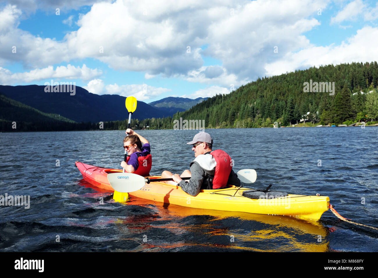 Tourists canoe boat, Alta Lake, Whistler Canadian Rockies Stock Photo