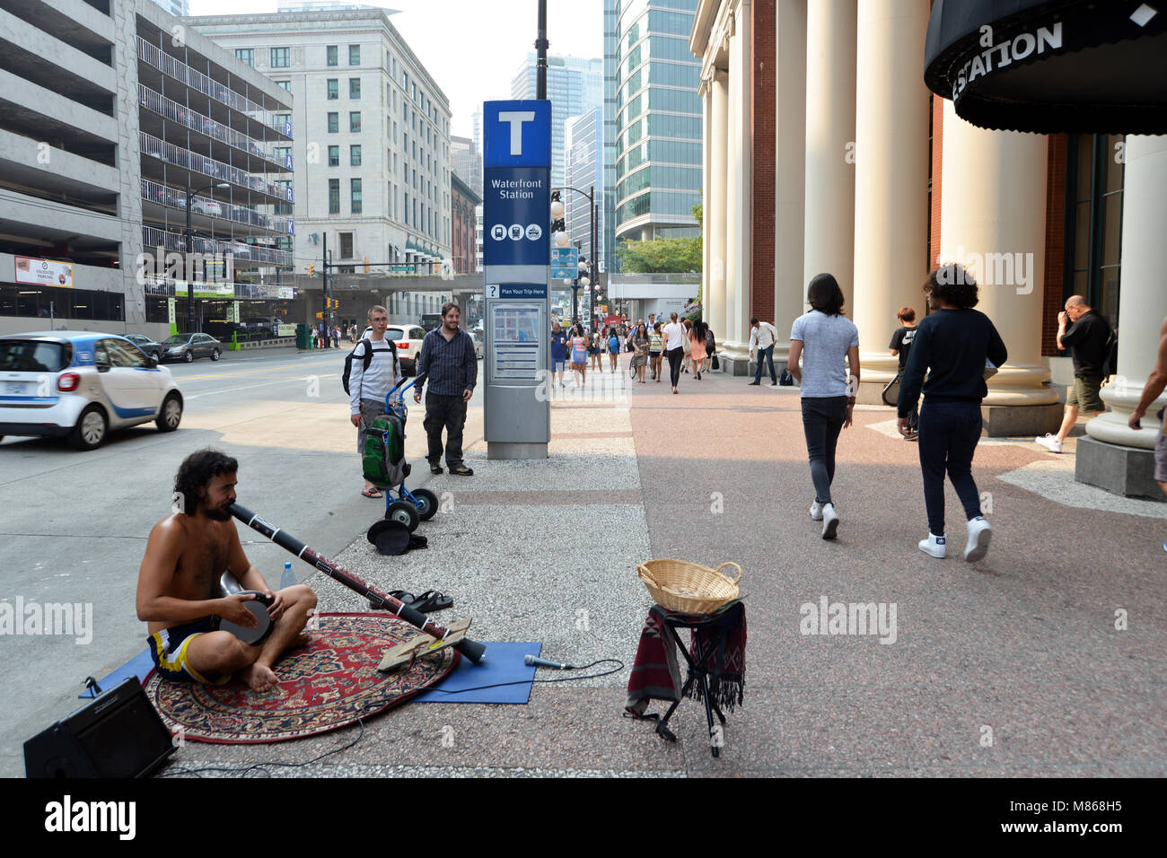 Busker plays a didgeridoo Vancouver, Canada Stock Photo