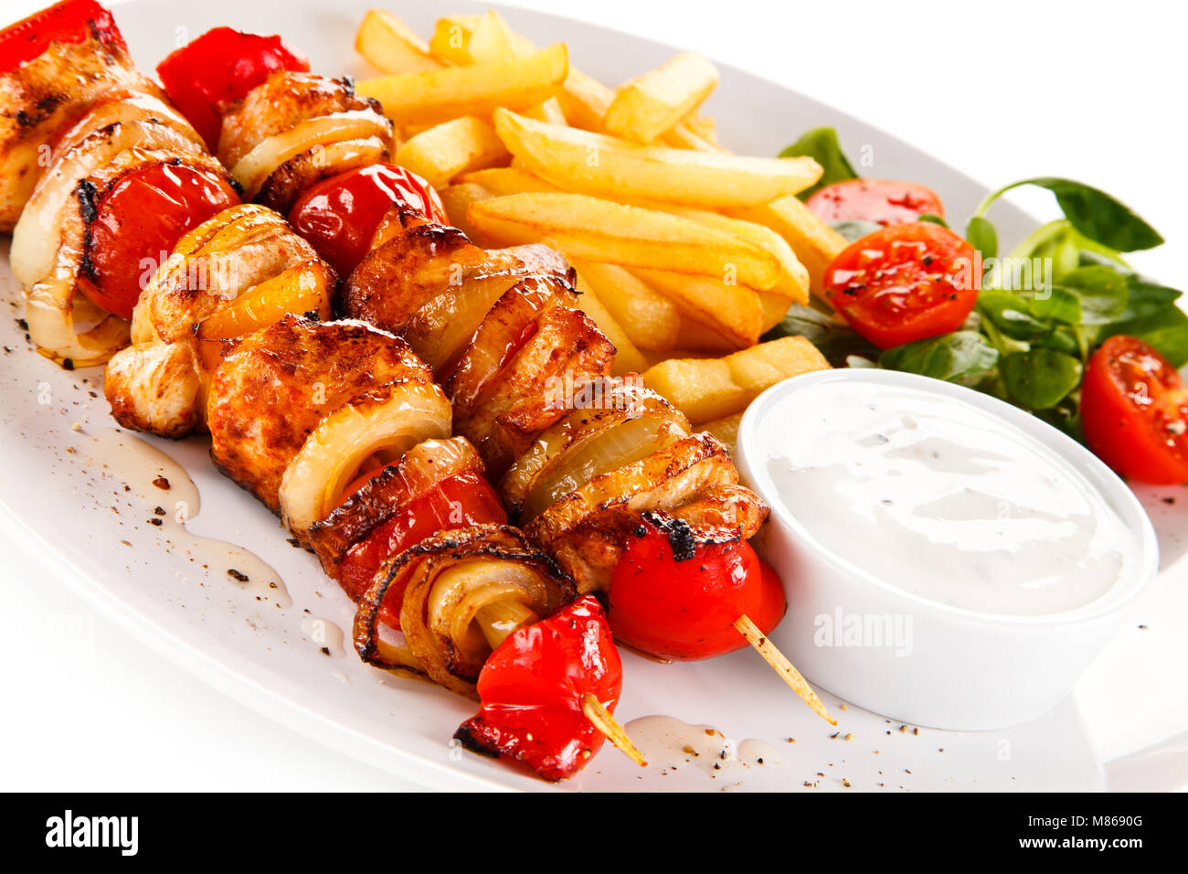 Kebab - grilled meat and vegetables on white background Stock Photo