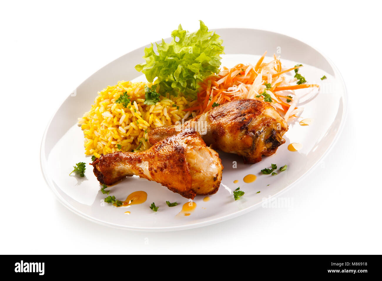 Roasted chicken drumsticks white rice and vegetables Stock Photo