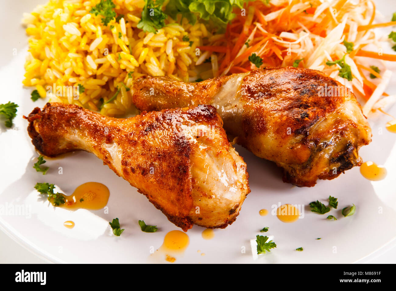 Roasted chicken drumsticks white rice and vegetables Stock Photo