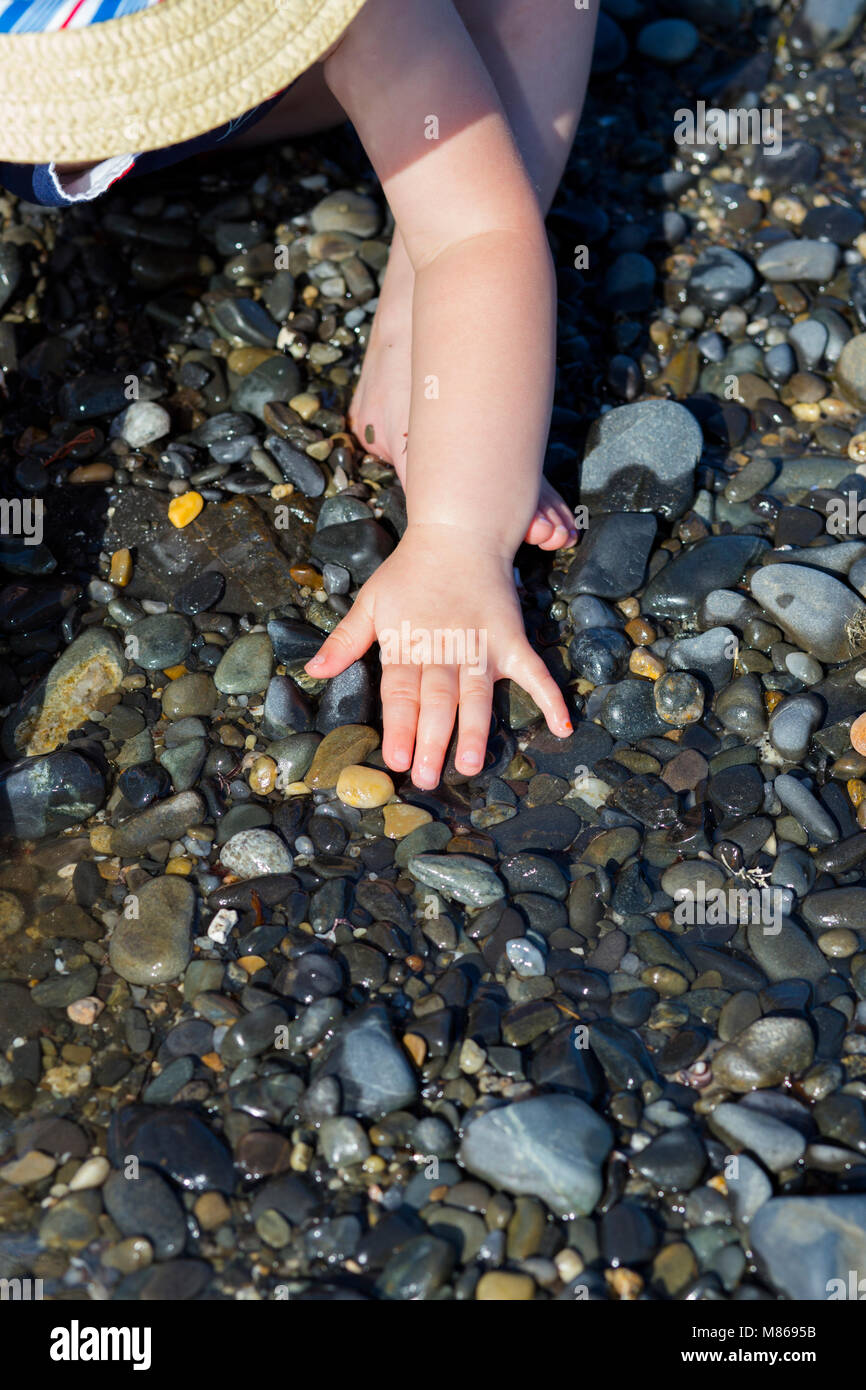 Little Girl Exploring  the Beach on a Sunny Summer Day in Kennebunkport, Maine Stock Photo