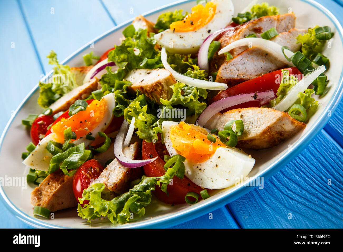Caesar salad on wooden table Stock Photo