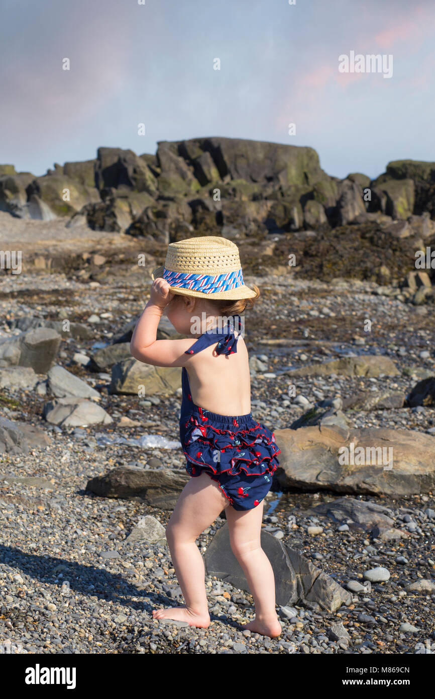 Little Girl Exploring  the Beach on a Sunny Summer Day in Kennebunkport, Maine Stock Photo