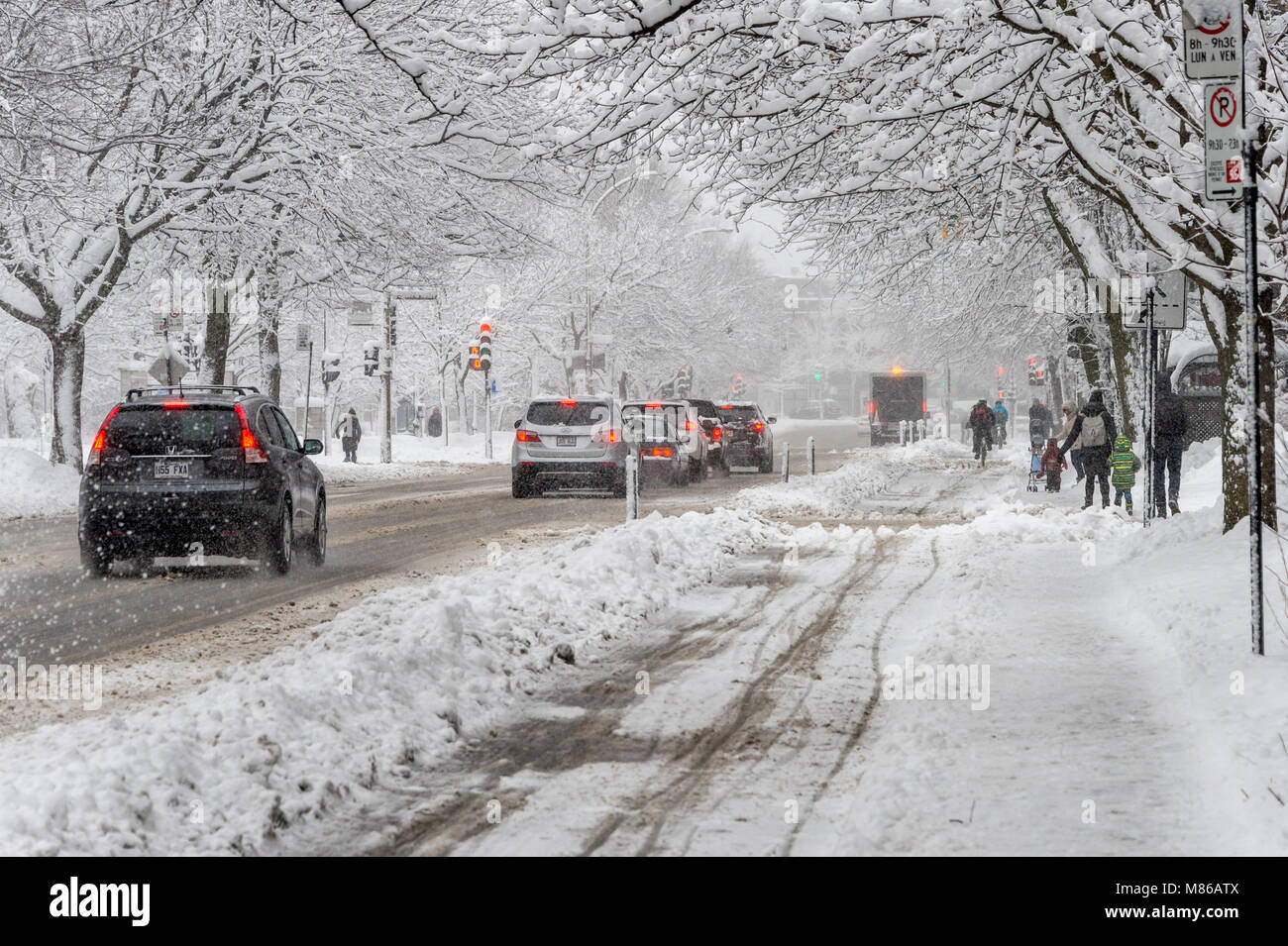 Montreal, CA - 14 March 2018: traffic on Rachel Street during winter snowstorm Stock Photo