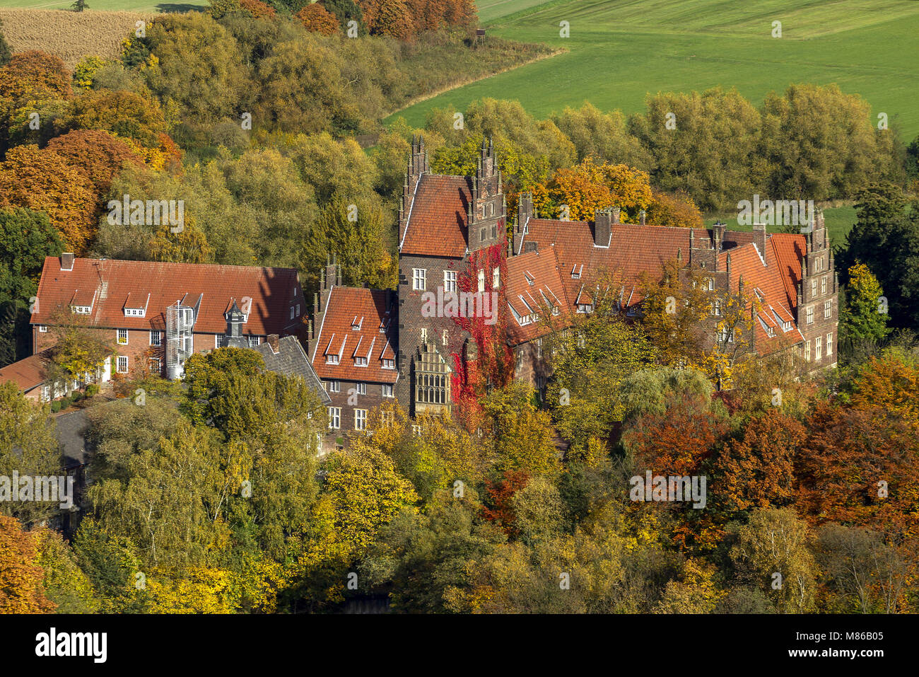 Aerial view, castle Heessen in autumn leaves, boarding school, moated castle, Hamm, Ruhr area, North Rhine-Westphalia, Germany, Europe, birds-eyes vie Stock Photo