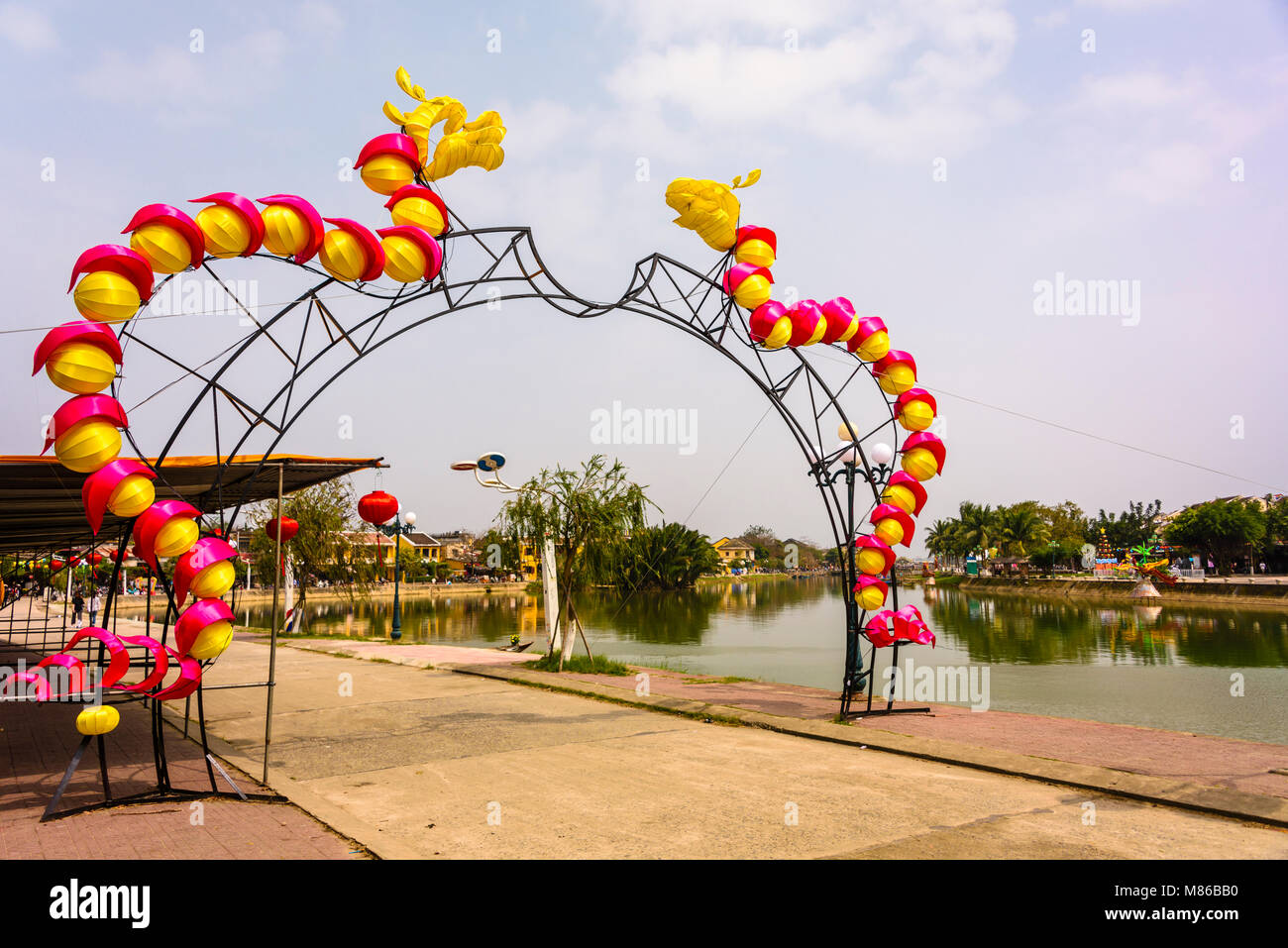 Red and yellow dragons on an archway to celebrate the Chinese Lunar New Year in Hoi An, Vietnam Stock Photo