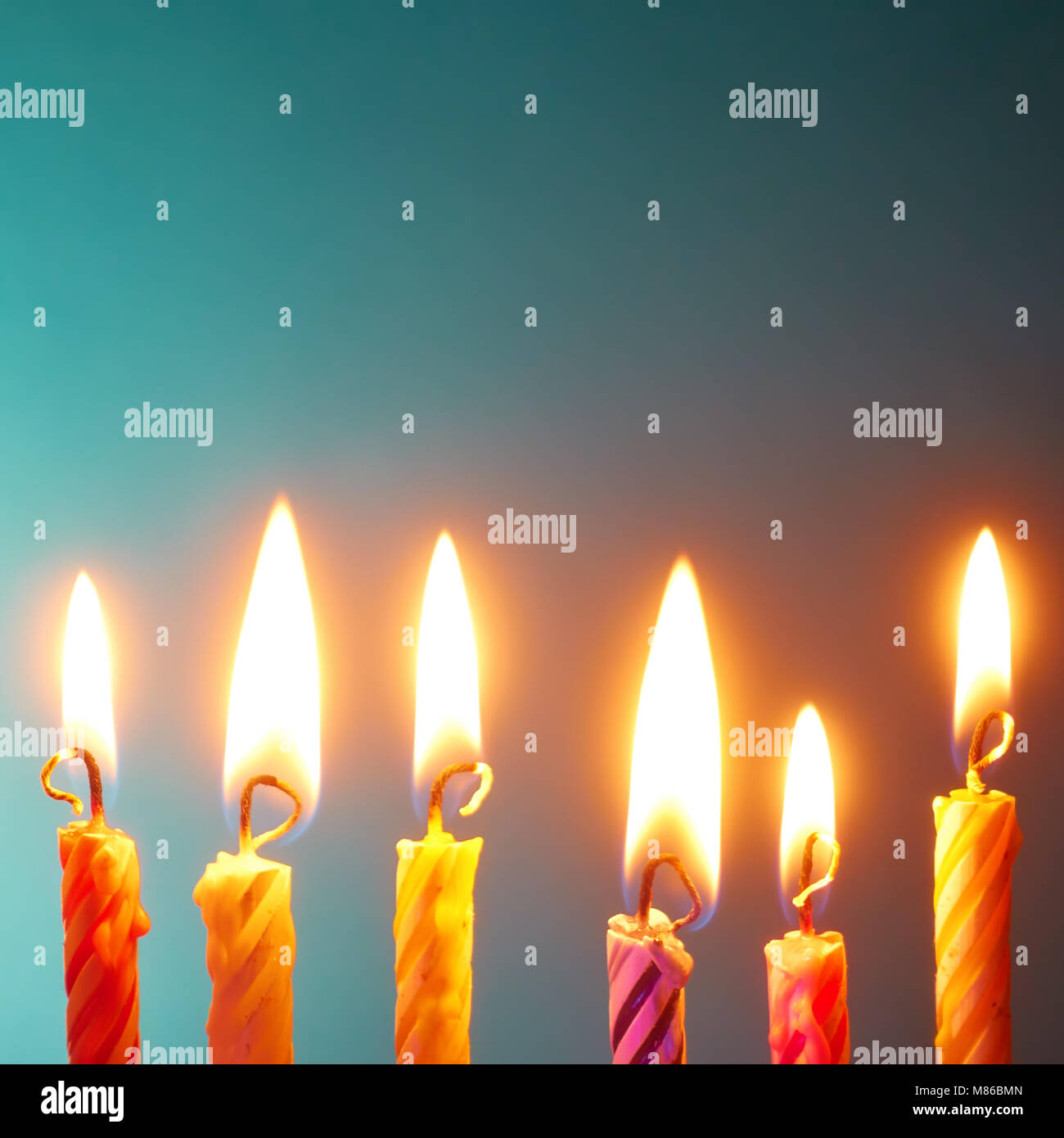 Holiday candles in a row close-up Stock Photo - Alamy