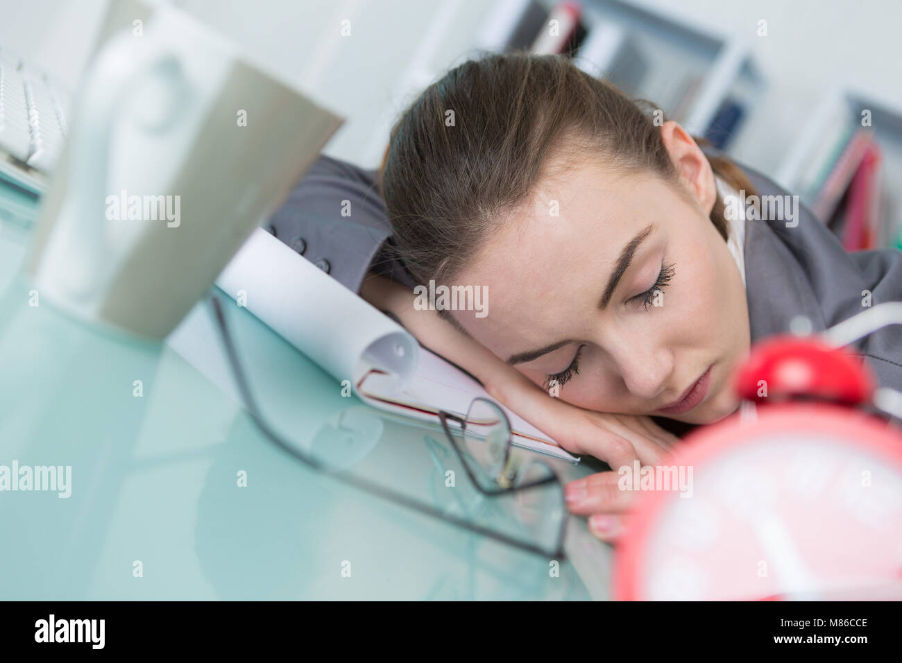 Woman asleep at her desk Stock Photo - Alamy
