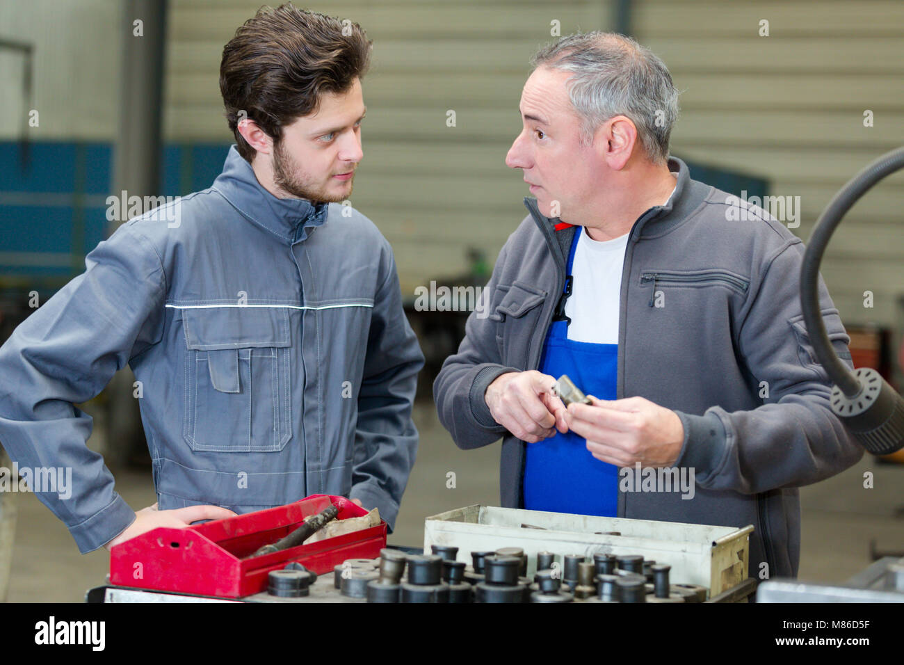 portrait of engineer and apprentice in factory Stock Photo - Alamy