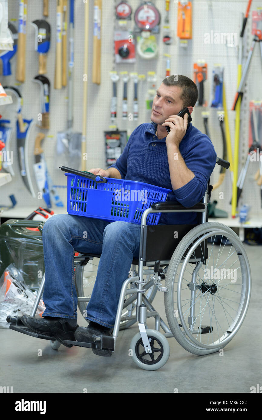 disabled man shopping in hardware store Stock Photo Alamy
