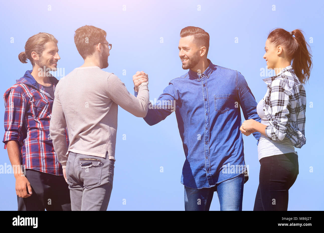 friends greet each other with a handshake Stock Photo Alamy